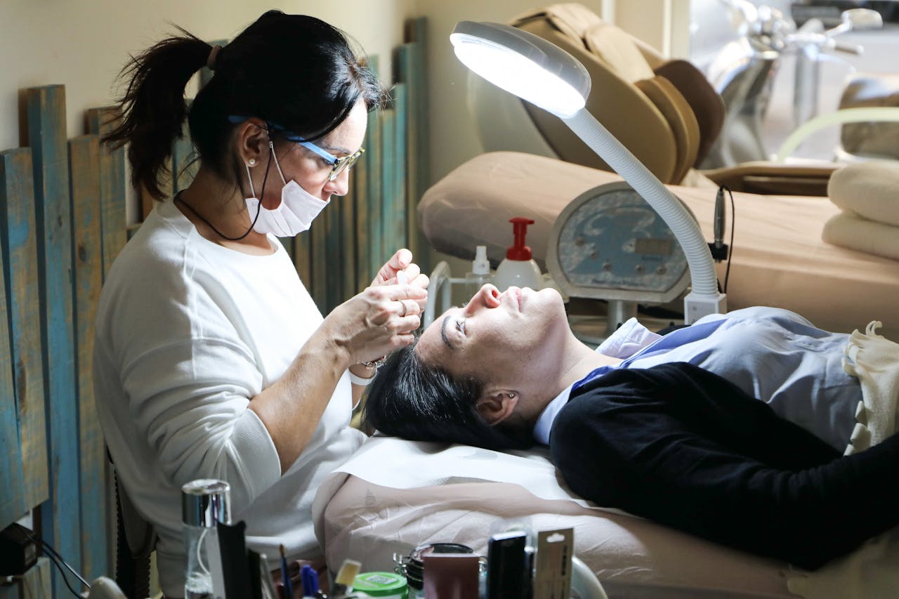 Beautician carefully performs a facial treatment on a woman in a spa setting, ensuring relaxation and care.